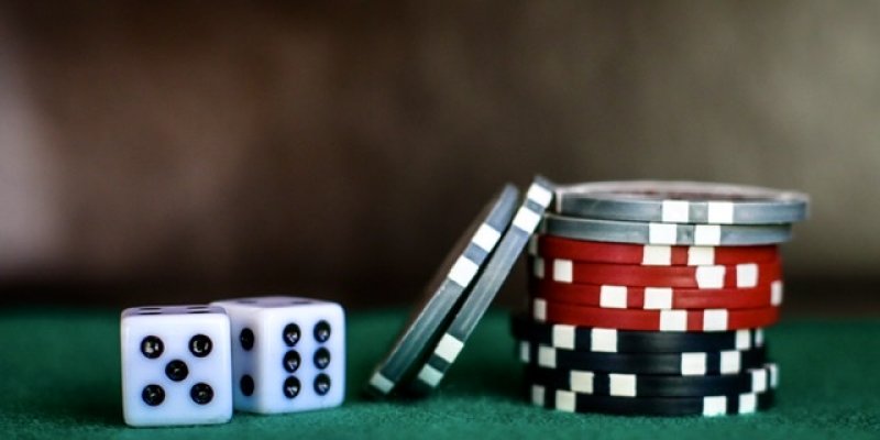2 dice and short stack of poker chips